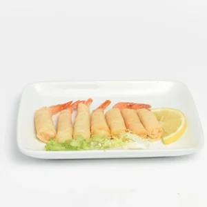 Overhead flat-lay shot of minimal golden shrimp rolls arranged neatly on a white rectangular plate, accompanied by a lemon wedge and fresh lettuce on a white background.