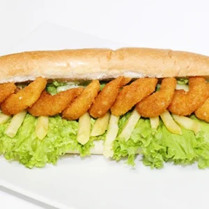 A submarine sandwich filled with crispy chicken fillets, fresh lettuce, and french fries, served on a white plate.