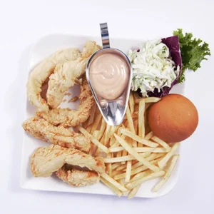 A white plate containing crispy fried chicken rings, golden fries, a soft bun, creamy coleslaw salad, and a stainless steel bowl of pink dipping sauce on a white background.