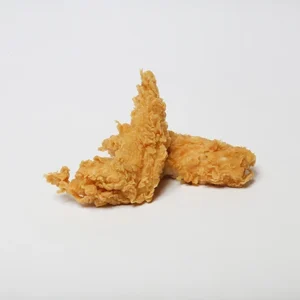 Two golden-breaded crispy fried chicken tenders resting on a clean white background, showcasing their crunchy texture.