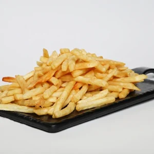 A large, towering pile of golden crispy French fries served on a rectangular black slate board, set against a plain white background.